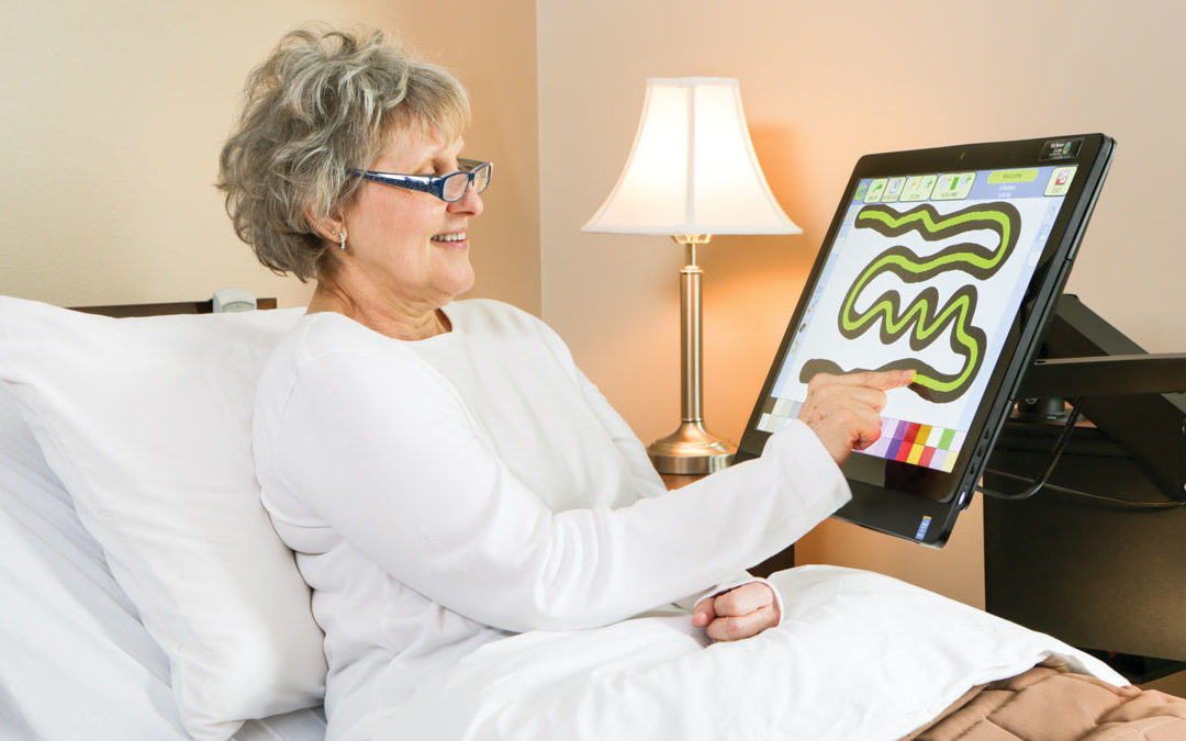 Elderly Woman in Bed Playing Game On Mounted Screen